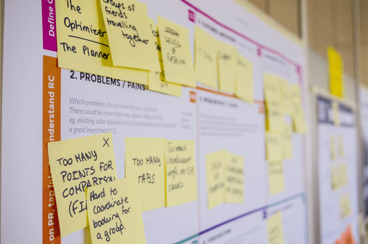 A board covered in sticky notes, symbolizing Agile management practices with tasks, priorities, and a visual representation of a dynamic and collaborative project management approach