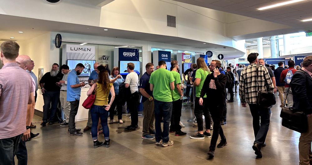 A photo of the stands or booths at the Silicon Slopes Summit held at Vivint Arena, showcasing the vibrant and innovative tech community