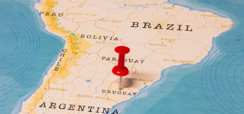 Map with a pin marking the location of Uruguay on it