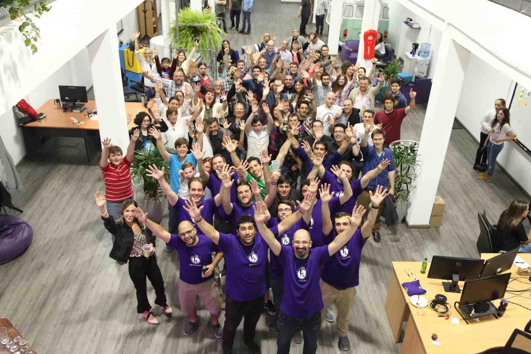 A lively photo capturing the Kaizen Softworks team members in celebration, marking the opening of their first office. The image features a group of individuals gathered together, expressing joy and camaraderie, symbolizing the exciting milestone in the company's history.